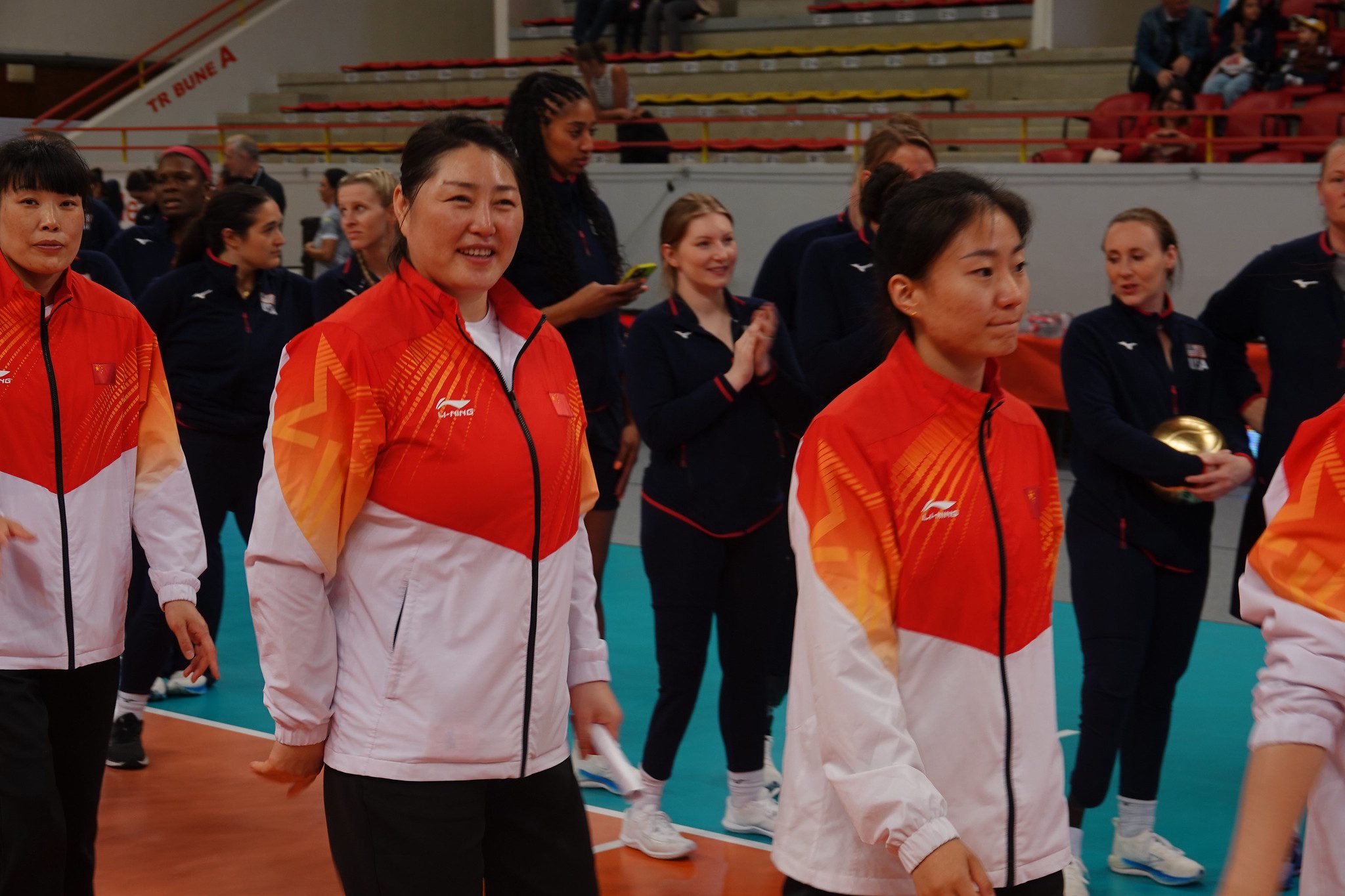 Adaptive sport athletes and coaches at a sitting volleyball event.