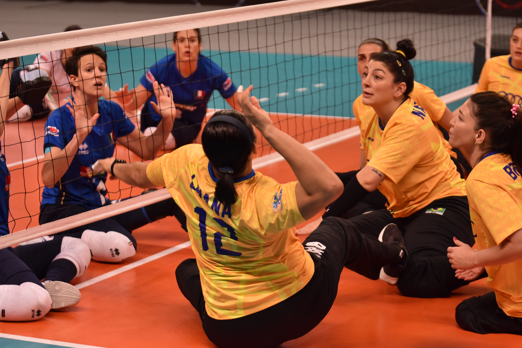 An adaptive sport team competing in sitting volleyball.
